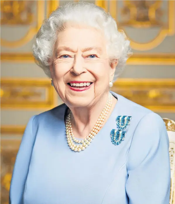  ?? ?? A new image of Queen Elizabeth II, taken at Windsor Castle in May, has been released by Buckingham Palace. She is wearing aquamarine clip brooches she was given by her parents on her 18th birthday in 1944