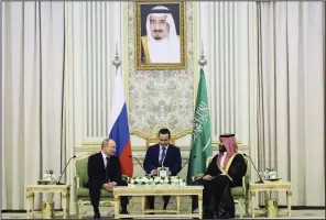  ?? (AP/Kremlin/Sputnik/Sergei Savostyano­v) ?? Saudi Crown Prince Mohammed bin Salman (right) and Russian President Vladimir Putin attend talks at the Al Yamamah Palace in Riyadh, Saudi Arabia, on Wednesday. At top is a picture showing Saudi King Salman.