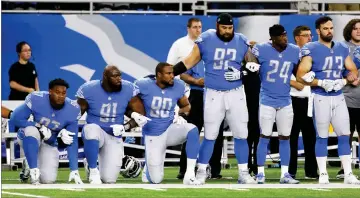  ?? AP PHOTO BY DUANE BURLESON ?? In a file photo from Sept. 24, Detroit Lions defensive end Armonty Bryant (97), defensive tackle A’shawn Robinson (91) and defensive end Cornelius Washington (90) take a knee during the national anthem before an NFL football game against the Atlanta...