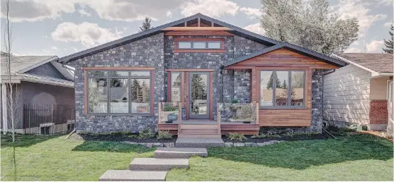  ?? PHOTOS: DON MOLYNEAUX. ?? Ultimate Renovation­s’ show home in Calgary features a natural stone front with Indonesian Batu wood trim and an additional 400 square feet of living space.