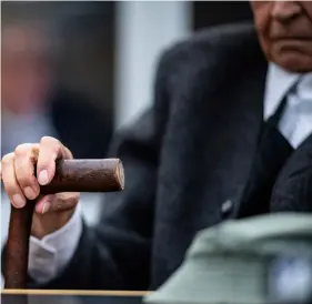  ??  ?? A former 94-year-old SS guard holds his walking stick at the beginning of a trial in Muenster, Germany, on Tuesday. He is charged of accessory to murder for serving at the Nazis’ Stutthof concentrat­ion camp. guIdo KIrchNer/dPA VIA AP