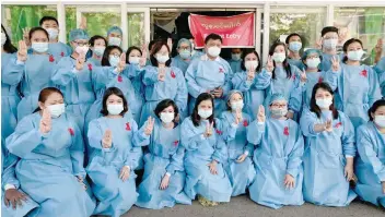  ?? — Reuters ?? Staff at scores of government hospitals across Myanmar stopped work on Wednesday or wore red ribbons in show of protest against the military coup.