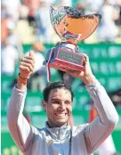  ?? AFP ?? Rafael Nadal holds up the Monte Carlo trophy.