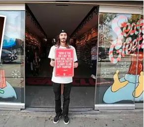  ??  ?? Tony Castillo stands at the entrance of Fight Club, on Fairfax Street in Los angeles, holding a rap quote sign by Shelowitz.