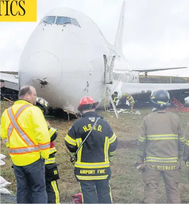  ?? ANDREW VAUGHAN / THE CANADIAN PRESS ?? A SkyLease Cargo jumbo jet with five people aboard skidded off a runway at Halifax’s Stanfield Airport, coming to a stop near a road early Wednesday. The airport suspended all flights after the incident.