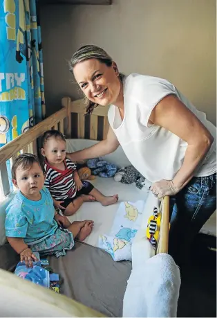  ?? Pictures: SIMPHIWE NKWALI ?? READY TO RUMBLE: Raylene de Villiers prepares year-old twins Hayden and Riley for a nap. Her sleeping aids range from hi-tech white noise to an old-fashioned lullaby