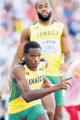  ?? GLADSTONE TAYLOR ?? Jamaica’s Nathon Allen (front) receives the baton for the second leg from Akeem Bloomfield during the men’s 4x400m relay final at the World Athletics Championsh­ips in Eugene, Oregon, on Sunday.