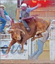  ?? FILE PHOTOS BY RANDY HOEFT/YUMA SUN Buy these photos at YumaSun.com ?? JOSE GRIEGO, FROM LAS VEGAS, N.M., aboard Midnight on Main, turns in the only full ride of the day in the bull riding event at last year’s rodeo. Griego scored a 64 for his effort.