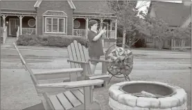  ?? Doug Walker ?? Kolton Hickey, 11, from Nashville, Tennessee is out taking a picture of a cardinal sitting on the back of a chair near a fire pit in front of one of the cottages at the Barnsley Resort.