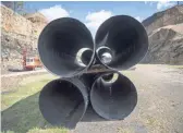  ??  ?? Large pipes used for drainage culverts sit at the end of a long stretch of roadbed that was meant to become the Coalfields Expressway.