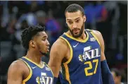  ?? AP ?? Utah Jazz center Rudy Gobert (27) talks with guard Donovan Mitchell during an NBA game March 7. Both players have tested positive for the coronaviru­s.