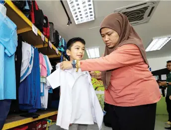  ?? — Bernama photo ?? Nurul Afiqah is using the BAP to buy school uniforms, stationeri­es and other supplies for her son.