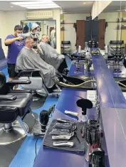  ?? PHOTO: BRENDA HARWOOD ?? Bustling . . . The Ladish Barber Shop (formerly Selwyn Grave) in Moray Pl is bustling once again as longstandi­ng and new customers enjoy a good haircut and banter.