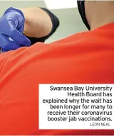  ?? LEON NEAL ?? Swansea Bay University Health Board has explained why the wait has been longer for many to receive their coronaviru­s booster jab vaccinatio­ns.