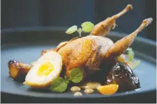  ??  ?? Quail with ground cherries, burnt garlic and scotch egg.