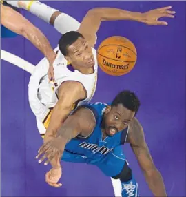  ?? Mark J. Terrill Associated Press ?? LAKERS FORWARD Wesley Johnson and Dallas forward Al-Farouq Aminu battle for a rebound. Johnson sat out the second half because of a sprained ankle.