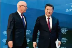  ?? by Lan Hongguang/ Xinhua ?? January 17, 2017: Chinese President Xi Jinping and Klaus Schwab, founder and executive chairman of the World Economic Forum ( WEF), during the opening plenary of the 2017 WEF annual meeting in Davos, Switzerlan­d, at which President Xi delivered a...