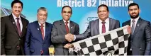  ??  ?? Balraj Arunasalam, DTM President 2017/2018, Toastmaste­rs Internatio­nal hands over the checkered flag to Kamil Hussain, Vice President, Sri Lanka Associatio­n of Racing Drivers and Riders (SLARDAR) signifying the launch of the ‘Get to the Point’ fun...