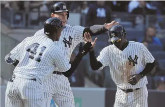  ?? AP PHOTO ?? WELCOME HOME: Didi Gregorius (right) is greeted by Aaron Judge (center) and Miguel Andujar after scoring in the Yankees’ 8-3 rout of the Orioles yesterday.