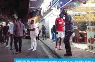  ??  ?? GUANGZHOU: File photo shows people gathering on a street in the ‘Little Africa’ district in Guangzhou, the capital of southern China’s Guangdong province. —AFP