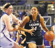  ?? Jeff Roberson / Associated Press ?? UConn’s Napheesa Collier drives past St. Louis’ Kendra Wilken during Tuesday night’s game in St. Louis.