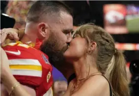  ?? Brynn Anderson/Associated Press ?? Kansas City Chiefs tight end Travis Kelce kisses Taylor Swift after the Super Bowl on Sunday.