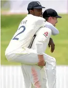  ??  ?? Jofra Archer gets a lift from teammate Rory Burns in Whangarei.