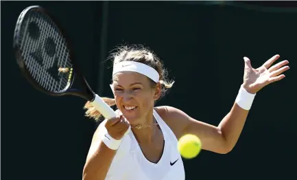  ??  ?? Victoria Azarenka of Belarus returns to Russia’s Elena Vesnina on day three at the Wimbledon Tennis Championsh­ips in London Wednesday. (AP)