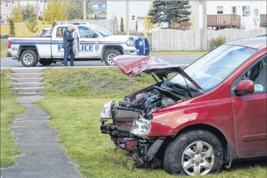  ?? JOE GIBBONS/THE TELEGRAM ?? A stolen van rests on a residentia­l lawn Wednesday after hitting a utility pole on Thorburn Road in St. John’s.