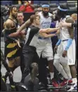  ?? Associated Press ?? HEATED — Officials separate Toronto Raptors guard Gary Trent Jr. (33) and Los Angeles Lakers center Montrezl Harrell (15) after Raptor’s OG Anunoby (3) threw the Lakers’ Dennis Schroder (17) to the floor after a foul during the first half on Tuesday in Tampa, Fla. Anunoby and Montrezl Harrell were ejected. The Lakers went on to win 110-101.