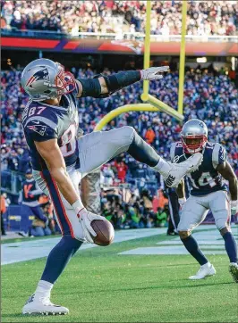  ?? ADAM GLANZMAN / GETTY IMAGES ?? Patriots tight end Rob Gronkowski celebrates one of his two touchdown catches Sunday. Gronkowski finished with five catches for 82 yards.