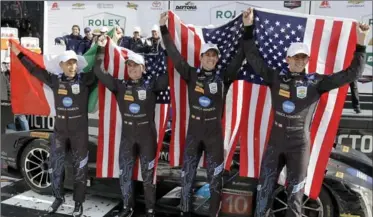  ?? ASSOCIATED PRESS FILE PHOTO ?? Winners of the IMSA 24-hour auto race, from left, Max Angelelli, Jeff Gordon, Ricky Taylor and Jordan Taylor celebrate in Victory Lane at Daytona Internatio­nal Speedway in January.