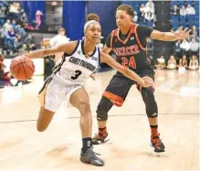  ?? STAFF PHOTO BY ROBIN RUDD ?? UTC’s Mya Long drives to the basket past Mercer’s Kahlia Lawrence during Saturday’s game at McKenzie Arena. Lawrence scored 17 points to help the Bears win 71-50 and remain undefeated in SoCon competitio­n. UTC had won 53 straight home games in league...