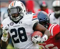  ?? AP/ROGELIO V. SOLIS ?? Auburn running back JaTarvious Whitlow (28) runs past an Ole Miss defender Saturday during the Tigers’ 31-16 victory over the Rebels in Oxford, Miss. Whitlow ran for 170 yards and 1 touchdown on 19 carries.