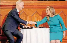  ?? [PHOTOS BY BRYAN TERRY, THE OKLAHOMAN] ?? U.S Rep. Steve Russell, left, and Kendra Horn shake hands before a debate between the two House 5th District candidates Wednesdayi­nside City Presbyteri­an Church in Oklahoma City.