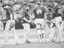  ?? JASON BEHNKEN THE ASSOCIATED PRESS ?? Toronto Blue Jays’ acting manager Russell Martin, second from left, takes relief pitcher Joe Biagini out of the game during the eighth inning.