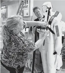  ?? Steve Gonzales / Houston Chronicle file ?? Viking Life Savings Equpment’s Jane Kragh and Henning Jense prepare their company’s booth before last year’s Offshore Technology Conference at NRG Center. The U.S. is expected to take the lead in oil production.