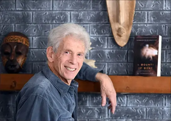  ?? JENNY SPARKS — LOVELAND REPORTER-HERALD ?? Author Peter Langfelder poses for a photo Friday at his home in Loveland.