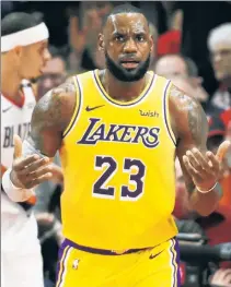  ?? Getty Images ?? CAN’T DO IT ALL: LeBron James reacts to a call in the second quarter of his first game with the Lakers, a 128-119 loss at Portland on Thursday night, despite his double-double of 26 points and 12 rebounds.
