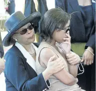  ?? Picture: VELI NHLAPO ?? ANOTHER FUNERAL: Lindiwe Hani sits on her mother Limpho’s lap at the funeral of her sister Khwezi