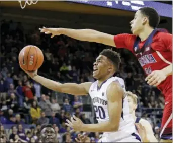  ?? ELAINE THOMPSON — THE ASSOCIATED PRESS FILE ?? Washington’s Markelle Fultz (20) looks for a shot during the second half of a game against Arizona last season in Seattle. Fultz is the biggest step in the right direction the 76ers, but he surely won’t be the last move. for