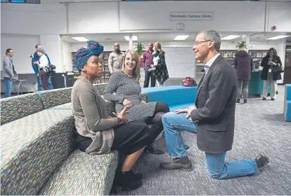  ?? Helen H. Richardson, The Denver Post ?? Denver Public Schools Superinten­dent Tom Boasberg chats with Montbello campus teacherlib­rarian Julia Torres, left, and DPS director of library services Caroline Hughes as they tour the new Montbello library this month. Friday is Boasberg’s last day as DPS superinten­dent. He’s had the job for nearly a decade.