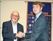  ?? Doug Walker / RN-T ?? Rome Exchange Club’s Frank Shropshire (left) presents a check for $500 to Armuchee senior Christophe­r Dean, winner of the club’s Accepting the Challenge of Excellence Award.