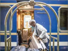  ?? AFP ?? A Blue Train butler loads passengers’ luggages at the departing hall of the train station in Cape Town, on February 25.