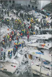  ?? AP/REBECCA BLACKWELL ?? Rescue workers search for people trapped inside a collapsed building Wednesday in the Del Valle area of Mexico City.