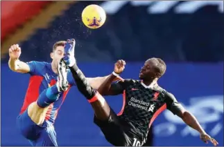  ?? POOL/AFP ?? Crystal Palace’s English defender Gary Cahill (left) vies with Liverpool’s Senegalese striker Sadio Mane during a football match at Selhurst Park in south London on Saturday.