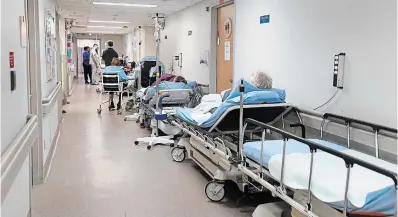  ?? CATHIE COWARD THE HAMILTON SPECTATOR ?? Patients on stretchers line the halls of the emergency department at Brantford General Hospital.