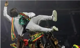  ?? February. Photograph: Sunday Alamba/AP ?? Aliou Cissé is lifted aloft by Senegal players after the Africa Cup of Nations victory in