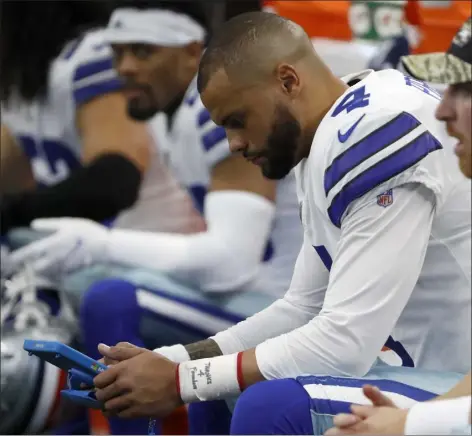  ?? Ap file ?? dallas Cowboys quarterbac­k dak Prescott sits on the bench during sunday’s game against the denver broncos.