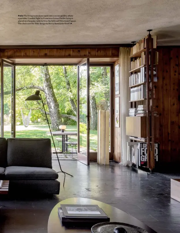  ??  ?? Patio The living room doors open onto a sunny garden, where a portable ‘Candela’ light by Francisco Gomez Paz for Astep is placed on a bespoke table by Gino Sarfatti and Vittoriano Viganò. The chairs are the ‘Side’ design by Harry Bertoia for Knoll